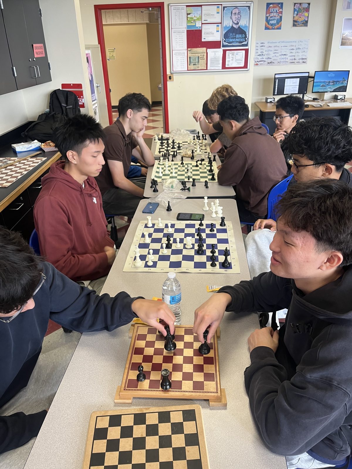Albany High School chess club members playing at several boards during a club meeting