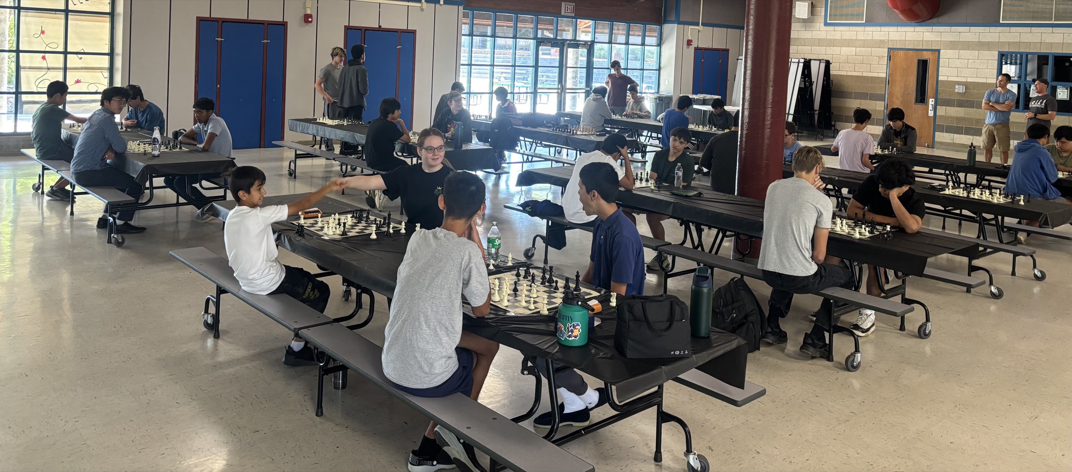 Students playing chess across long tables in the tournament hall at Rocklin, May 16, 2026